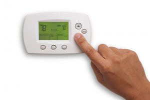 finger-on-thermostat